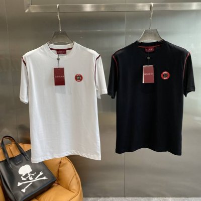 古家 Guccit恤 黑白间的经典与活力碰撞 领口处显眼的红色细节，为整体造型增添了一抹亮色。胸前那标志性的圆形标识，彰显着品牌的独特风格。面料柔软又透气，穿着