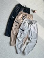 HELLY HANSEN山系户外复古口袋设计松紧腰宽松运动束脚休闲裤 男女同款 -颜色：黑色 灰色 卡其尺码：M-3XL设计感户外休闲长裤 高腰设计，宽松裤型
