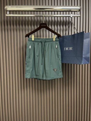 prada 2025Ss春夏新款三角标尼龙沙滩短裤，这款短裤采用优质面料，手感柔软舒适，透气性良好，适合各种场合穿着。松紧腰头设计，穿脱方便，适应不同身材，提供