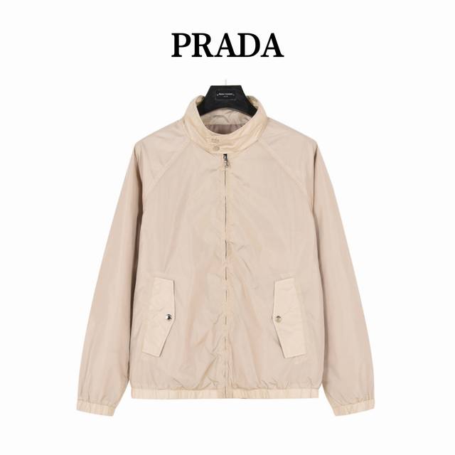 prada 普拉达 后背三角标轻薄外套 贸易渠道稀出，海外精品限量销售。户外风衣产品的典范，全身暗纹的商标彰显品牌辨识度。这款夹克兼备温暖且轻盈的特质。 最新款