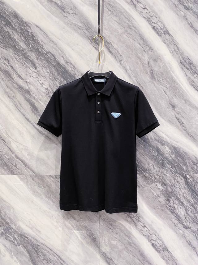 新品 三角经典 Polo衫 柜台同步发售 Pd的新秀丽作. 贸易渠道货品,为数稀少！ 2025Ss春夏新品 P家男士商务休闲时尚饰带装饰标识设计翻领短袖T恤 常
