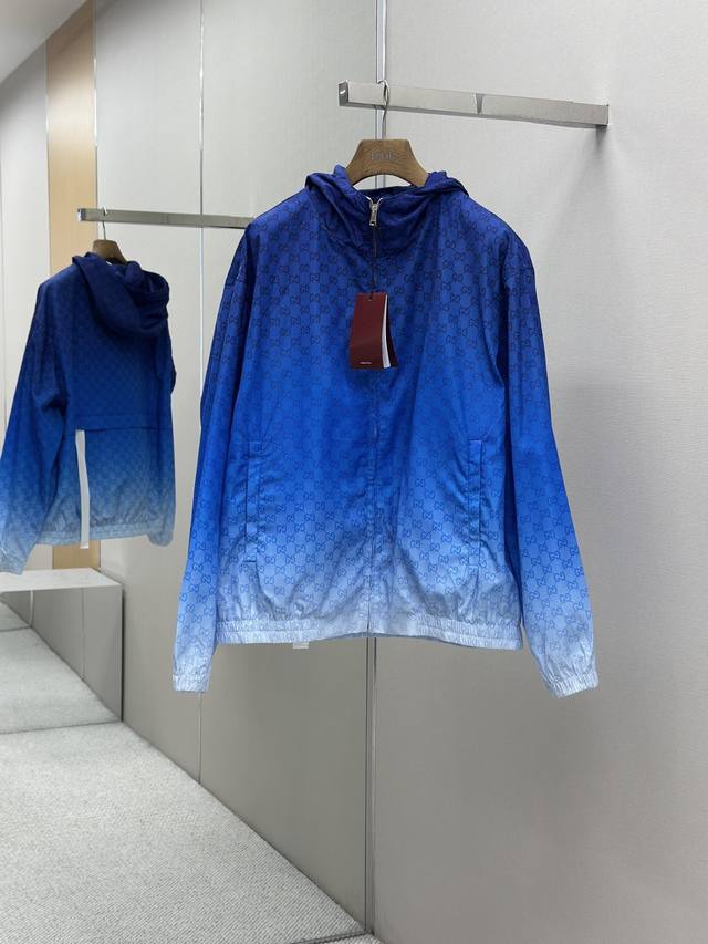 Gucci古驰梭织渐变印花连帽长袖外套 采用梭织棉面料匠心制作，面料舒适亲肤，透气吸汗，成衣渐变蓝白设计，满身饰以经典品牌印花图案，固定兜帽，带内层抽绳，弹力松