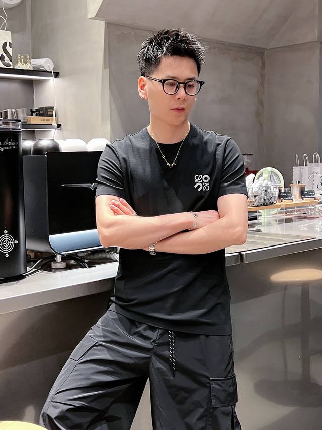 Loe 2025Ss春夏新款圆领短袖T恤，非常适合这个充满活力的季节。这款T恤采用高级定制面料，触感柔软舒适，透气性好，适合春夏季节穿着。经典新元素Logo设计