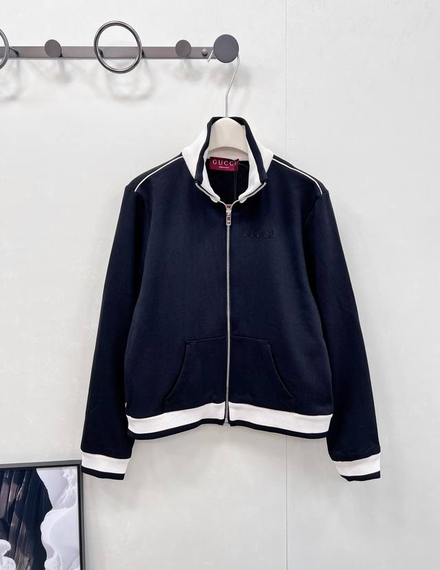 Gucci 新款刺绣字母经典立领拉链夹克，黑白配色利落又高级，领口、下摆、袖口的白色饰边，勾勒出精致轮廓。胸前低调的 Gucci 字母刺绣，是品牌基因的优雅彰显
