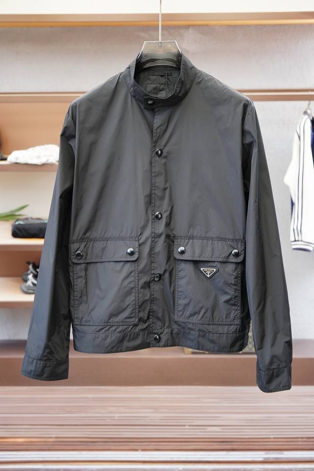 Prada-普拉达-25春夏新款Pr*Da金属三角标识小立领轻薄夹克防晒衣，男士工装双口袋轻质尼龙外套。上海恒隆柜台订单，官网同步发售。简洁的金属按扣开合，小立