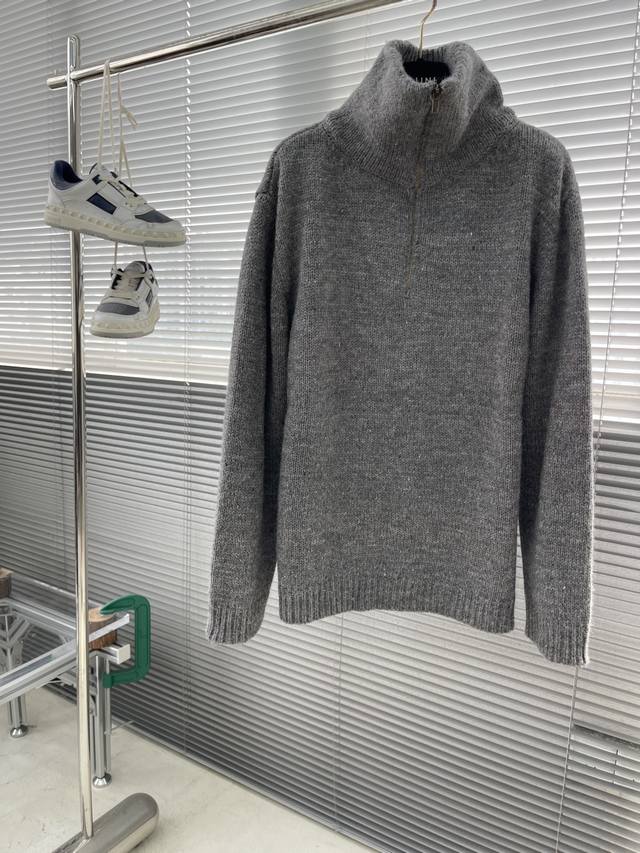 Mm6 马吉拉 25Fw羊毛混纺半拉链毛衣 这件毛衣的基石是专属开发定纺的羊毛混纺纱线。其复杂性在于，并非通过后整染色达成，而是在纺纱阶段，将多种不同色相 如灰