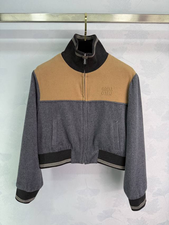 Miu*25秋冬新款灰橙撞色短款夹克，Holiday系列新品，羊毛混纺材质，柔软又保暖。灰橙拼接黑色高领，活力满满，胸前品牌刺绣超有辨识度。短款剪裁拉链设计，穿
