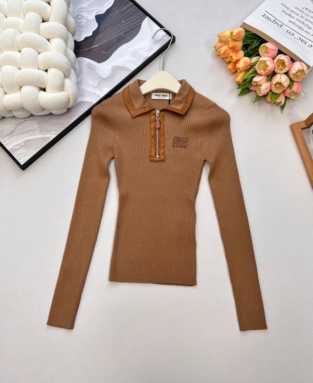 Miumiu2025新款字母皮标拼皮翻领针织上衣，定制Yb羊绒纱线织造，质感高级，舒适柔软，翻领正肩长袖毛衣版型，半开襟麂皮轮廓包边拉链设计，搭配竖坑条肌理，突