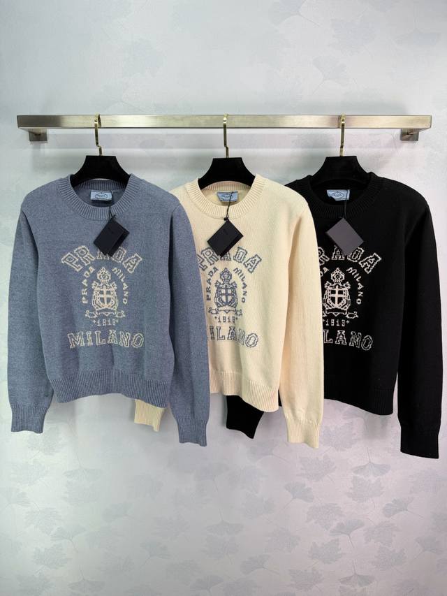 pr*25秋冬新款学院风徽标毛衣，采用柔软羊毛穿着舒适亲肤。胸前盾徽刺绣徽标+字样，辨识度超高。罗纹圆领，包容性强，单穿或内搭都很Ok，轻松打造随性时髦感！3色