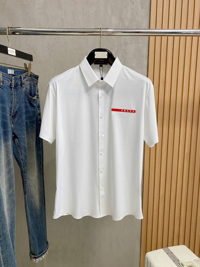 普拉达25Ss春夏新款翻领polo。精选天丝棉贡缎棉料，舒适细腻带来极佳的亲肤感，同时吸湿透气，W方便打理。精工螺纹现织领口，修饰身形同时更不易变形，5与细节处