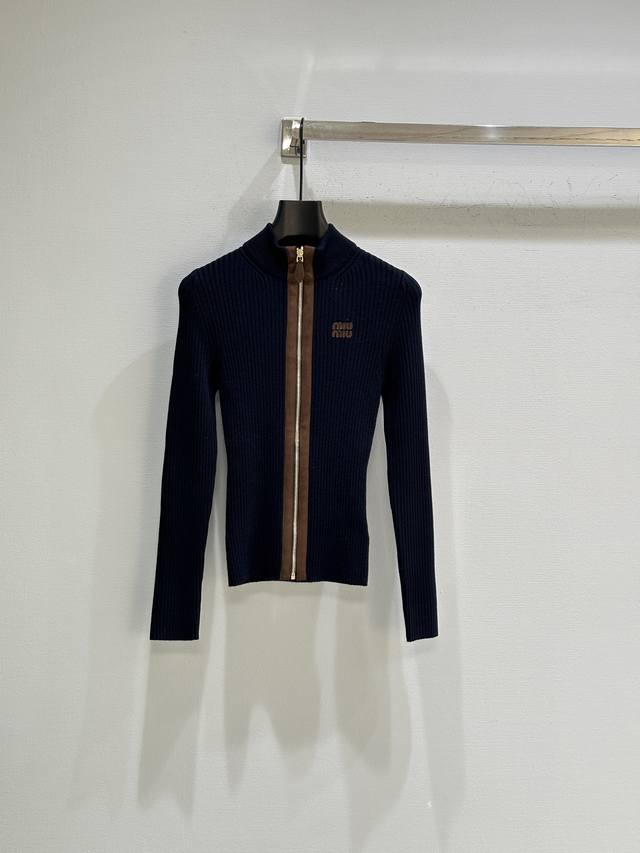 25Ss秋冬新款上新！精致的罗纹针织工艺定义了这款羊绒开衫的修身版型，领口、徽标和拉链上的皮革饰边巧妙地体现了Miu Miu的工艺匠心和现代美学。现货供应藏蓝色