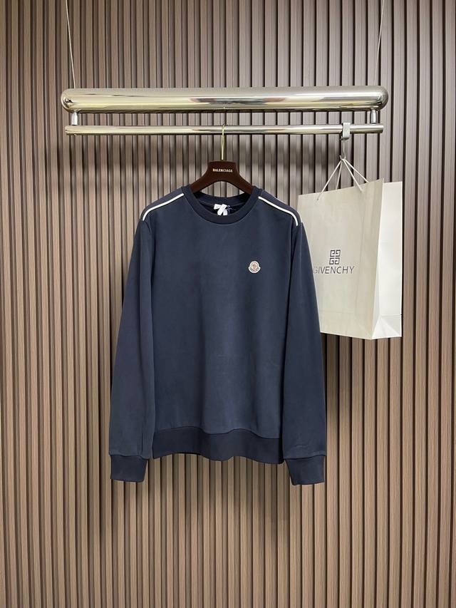 Moncler 圆领标识棉质长袖卫衣，这款深蓝色圆领卫衣采用高密度棉混纺面料，触感柔软且具有良好的透气性与回弹性。领口采用双针车缝工艺，平整牢固，有效防止变形。